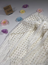Load image into Gallery viewer, Crochet cover up wrap skirt tied and laid flat with the tie on top